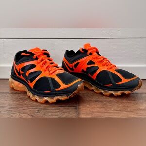 Nike Air Max 2012 running shoe in a black and orange colorway. 
Size: 4.5Y